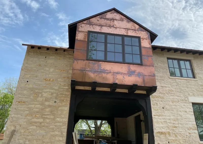 Copper metal panel facade on a stone building for Roof Repair in Lower Merion